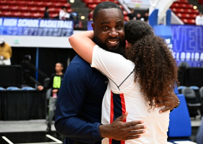 Miami Country Day head coach Ochiel Swaby is hugged by Kayla Nelms after the team won back-to-back Class 3A state championships at the RP Funding Center in Lakeland on Friday.